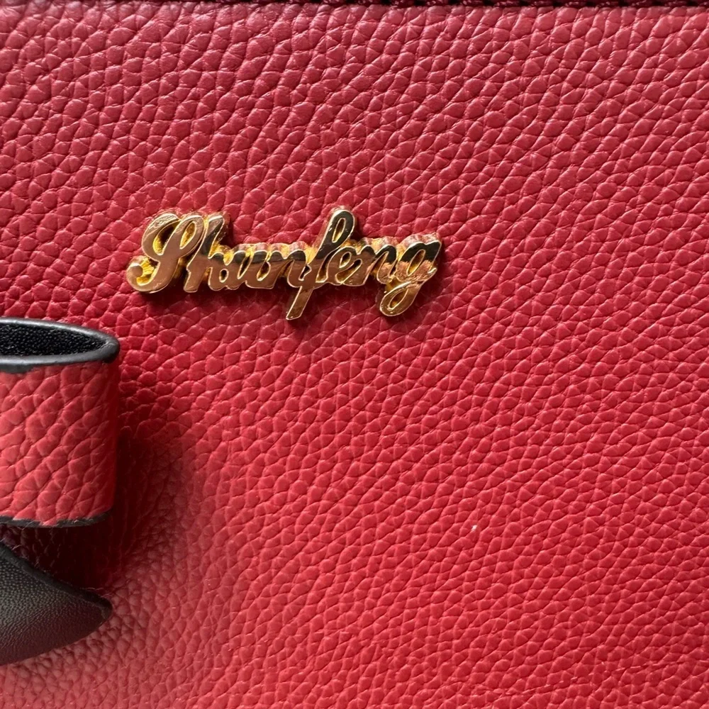Charming Red Satchel with Bow by [Brand]